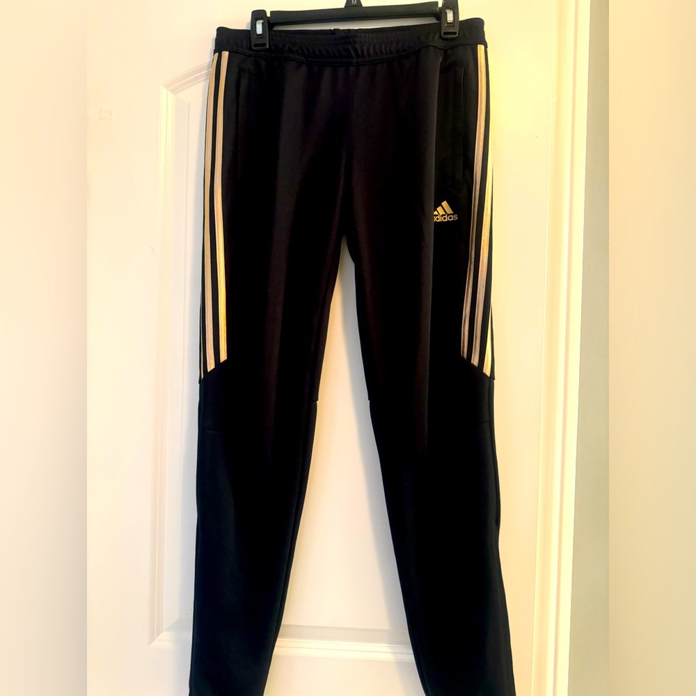 Unisex Adidas soccer pants black and gold.
